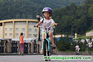 Маленькая девочка катается на велосипеде